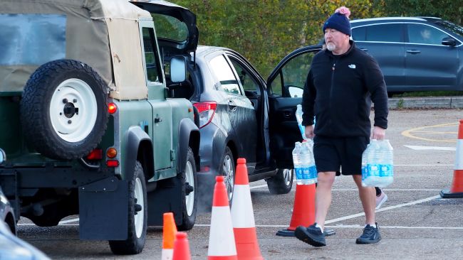 Local residents collect bottles of water in Godalming, Surrey, as almost 12,000 people remain without running water in areas including Guildford and Godalming, after Storm Ciaran caused problems at a treatment plant in Surrey. Picture date: Monday November 6, 2023.

