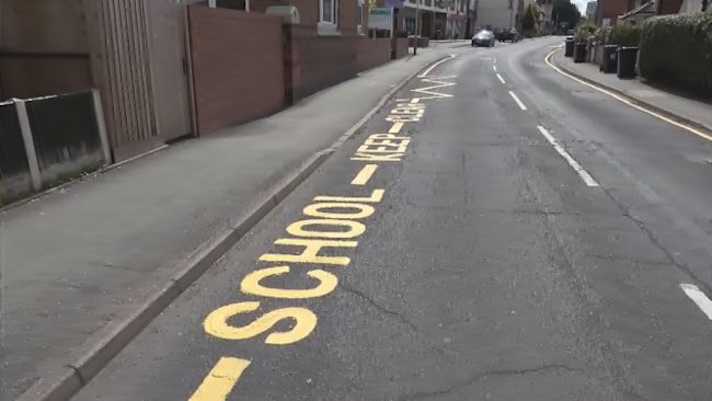 School road markings in Wolverhampton - outside old school that's been closed for a decade. School Keep clear road marking.