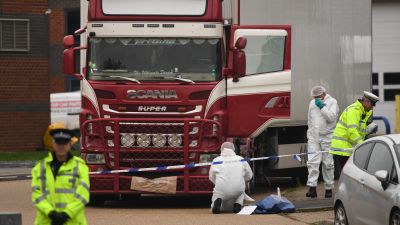 File photo dated 23/10/19 of police and forensic officers at the Waterglade Industrial Park in Grays, Essex, after 39 bodies of Vietnamese migrants were found inside the lorry on the industrial estate. Four people-smugglers could be facing life sentences for the manslaughter of 39 migrants who died in the back of a trailer.
