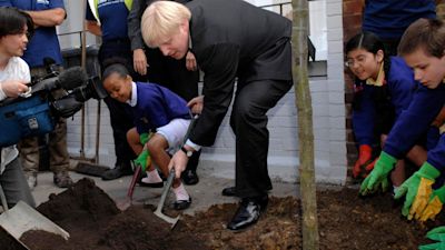 London Mayor Boris Johnson along with pupils from King's Avenue Primary School helps to plant a tree in Brixton, south London, at the launch of his pledge for 10,000 new street trees in the city. Tim Ireland/PA