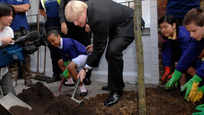 London Mayor Boris Johnson along with pupils from King's Avenue Primary School helps to plant a tree in Brixton, south London, at the launch of his pledge for 10,000 new street trees in the city.  Tim Ireland/PA 