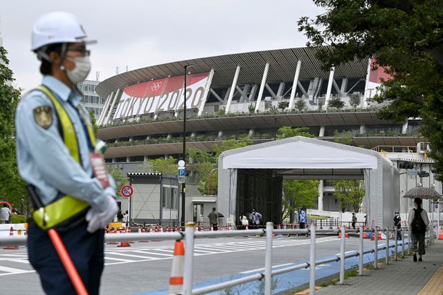 A security worker stands near the Olympic stadium in Tokyo