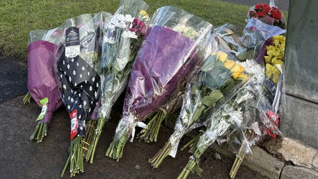 Tributes left at the scene in Kennerleigh Avenue, in the Austhorpe area of Leeds