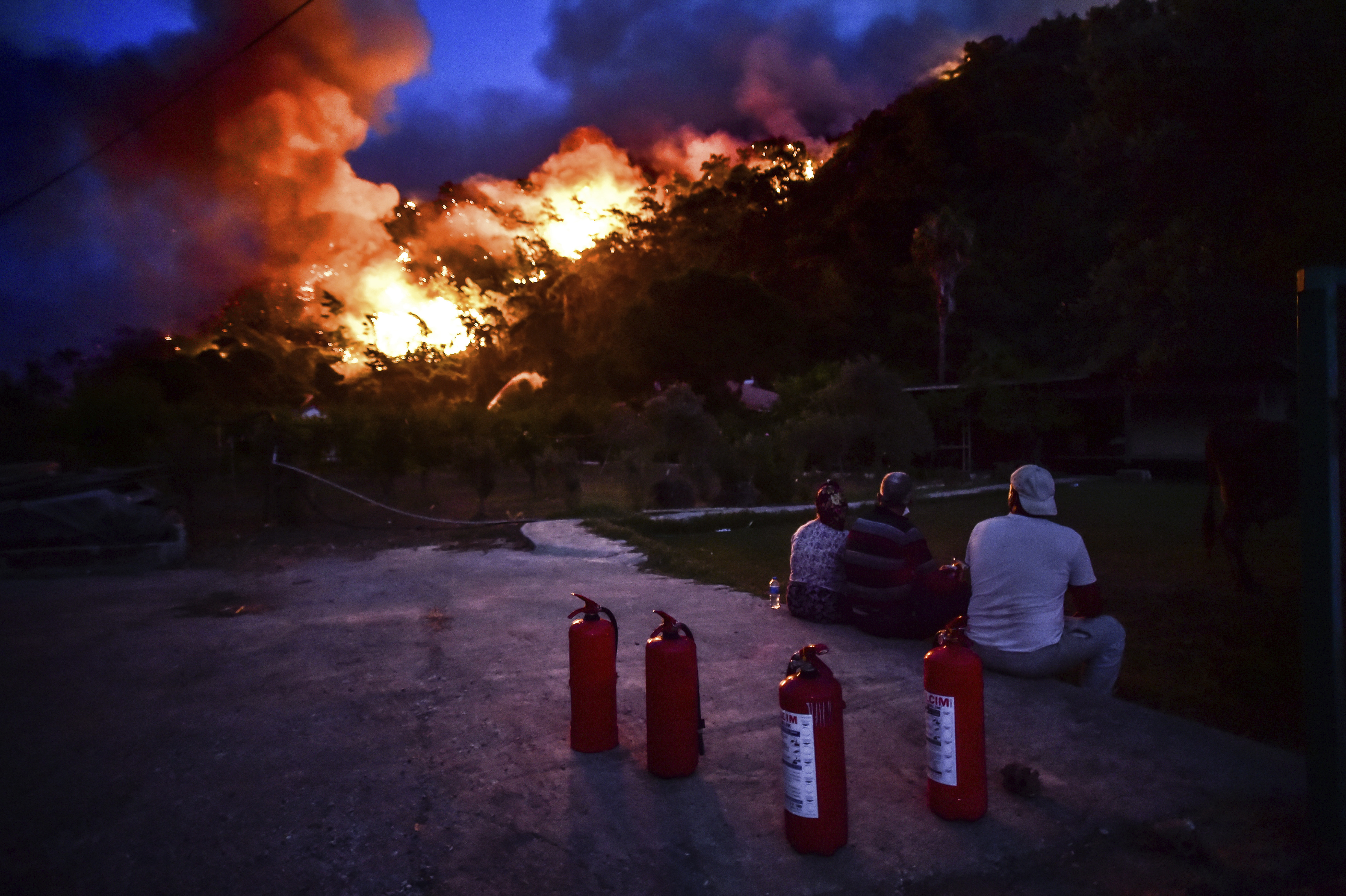People watch advancing fires in Hisaronu