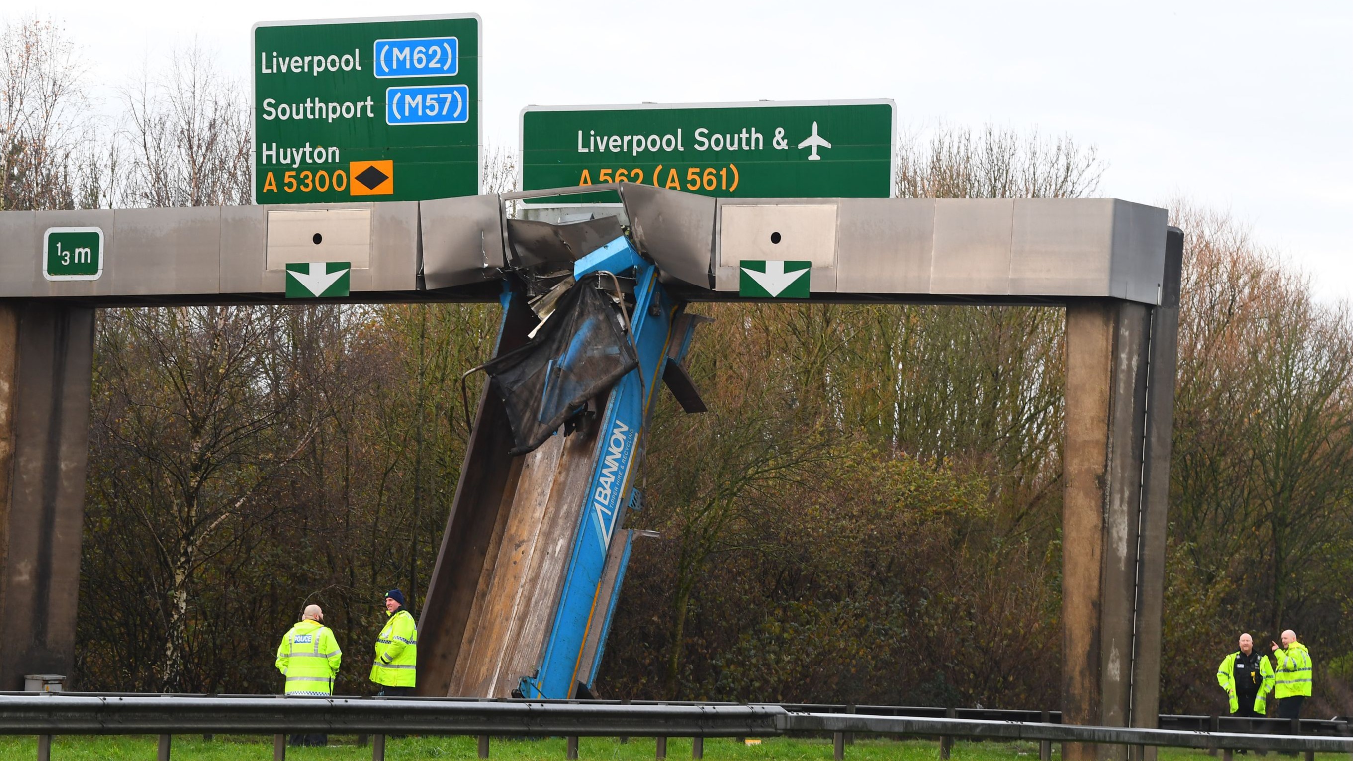 Lorry crashes into overhead gantry on Merseyside causing major