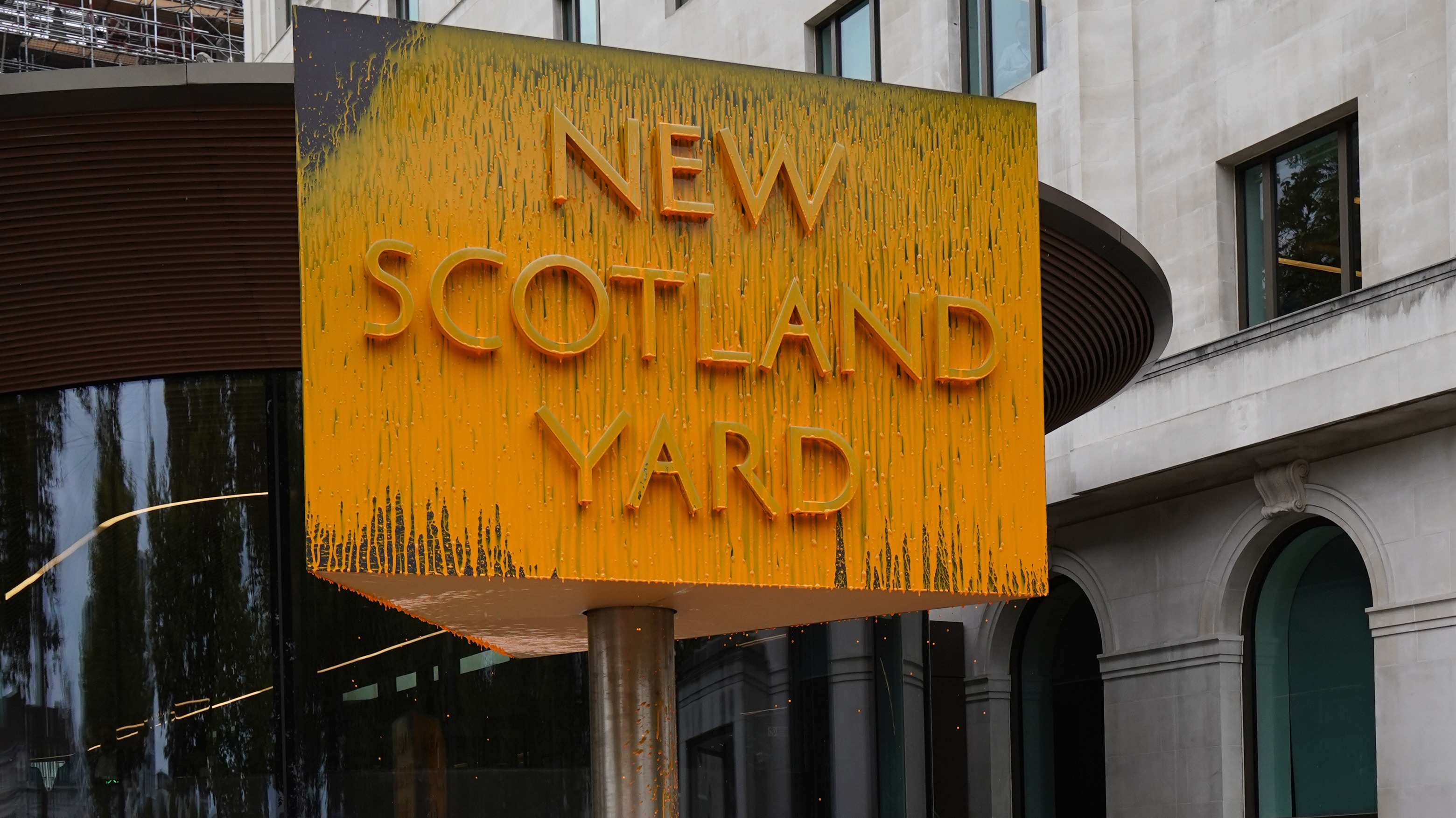 New Scotland Yard sign covered with yellow paint as protesters target  Metropolitan Police HQ