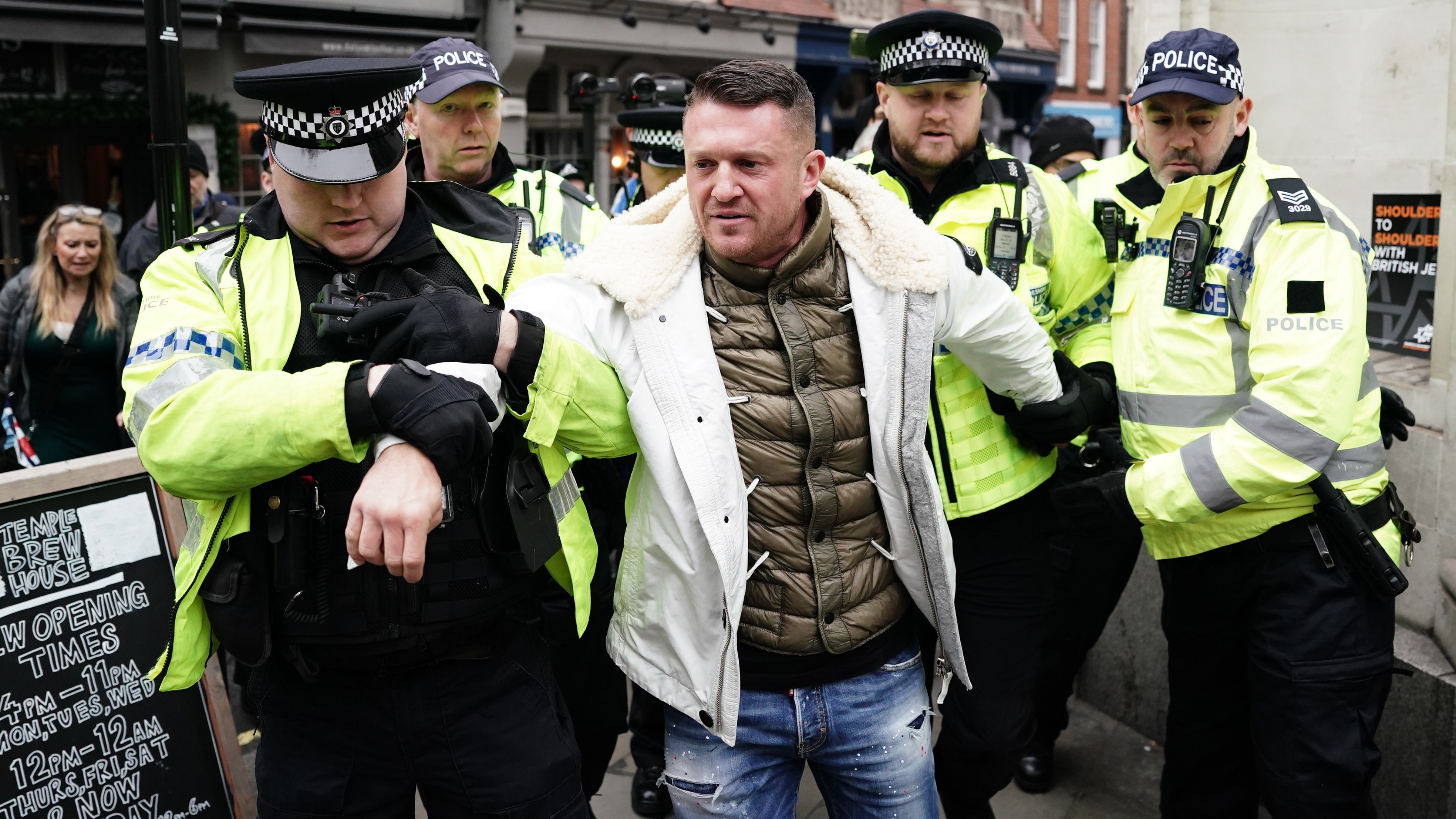 EDL founder Tommy Robinson escorted from antiSemitism rally as