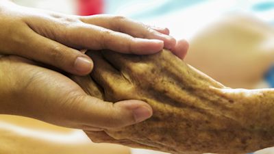 Hands being held in care home