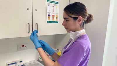 Nurse draws up Covid jab