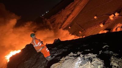 Firefighters tackling the blaze a landfill site.