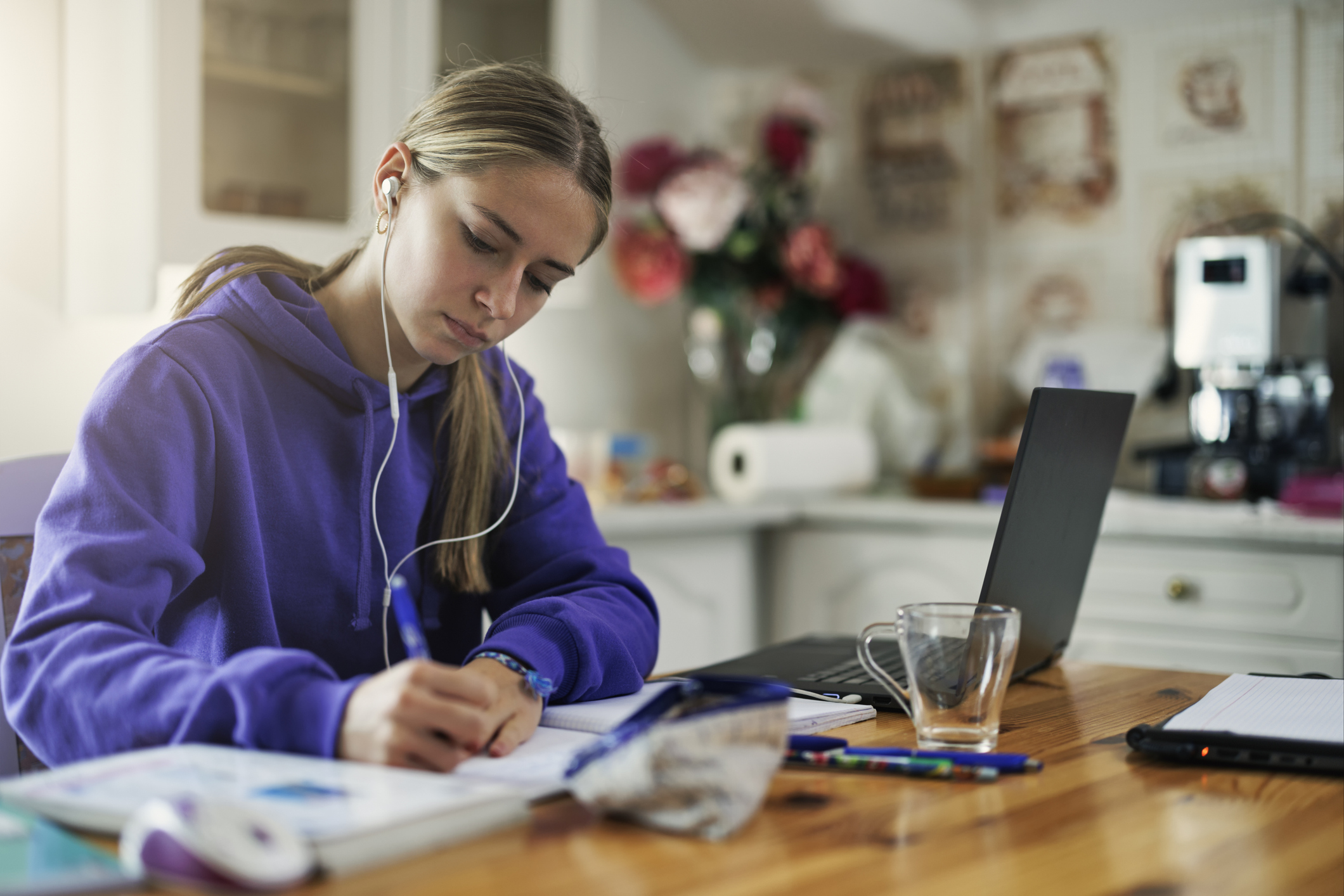 A student studies in the kitchen