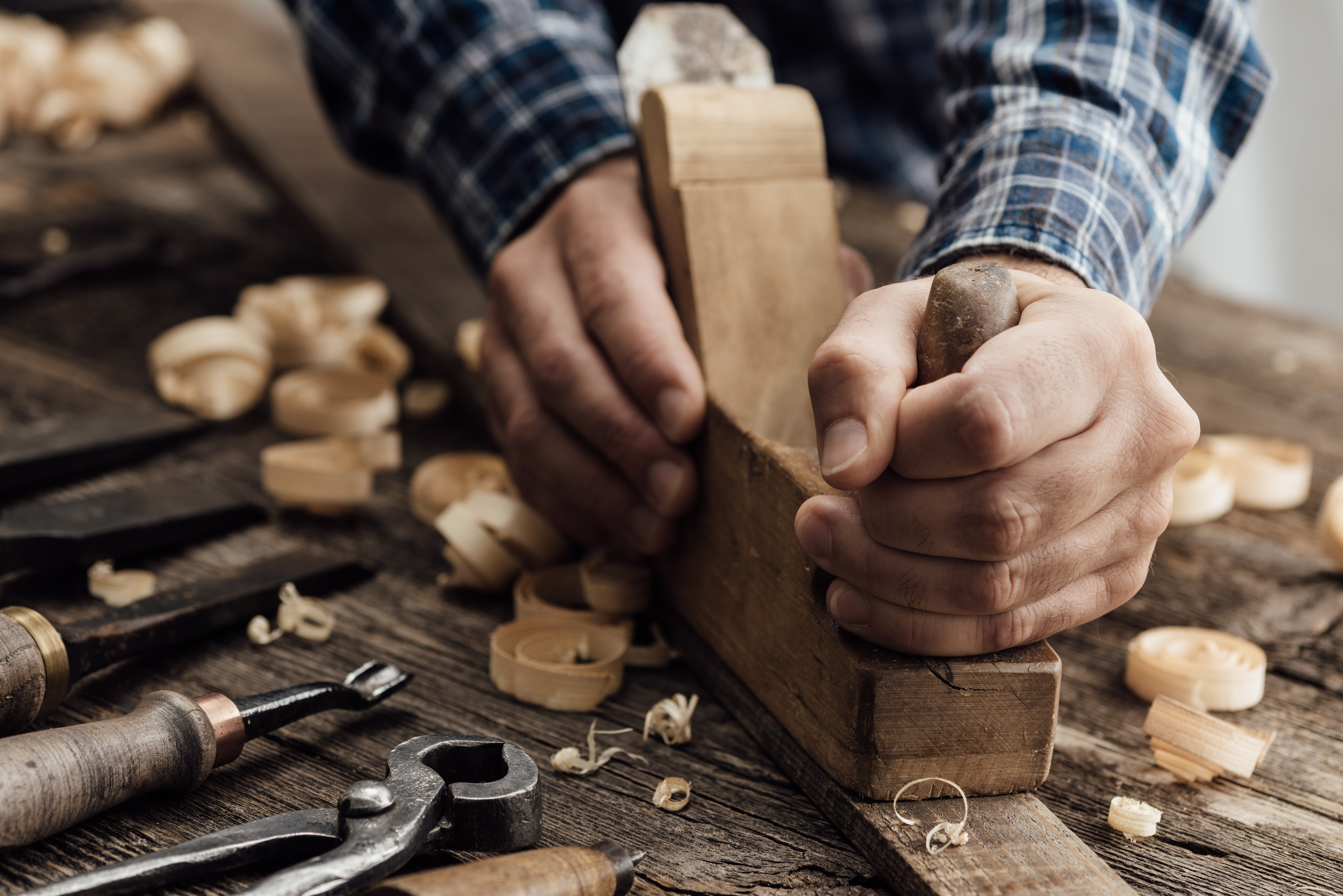 A craftsman carves wood