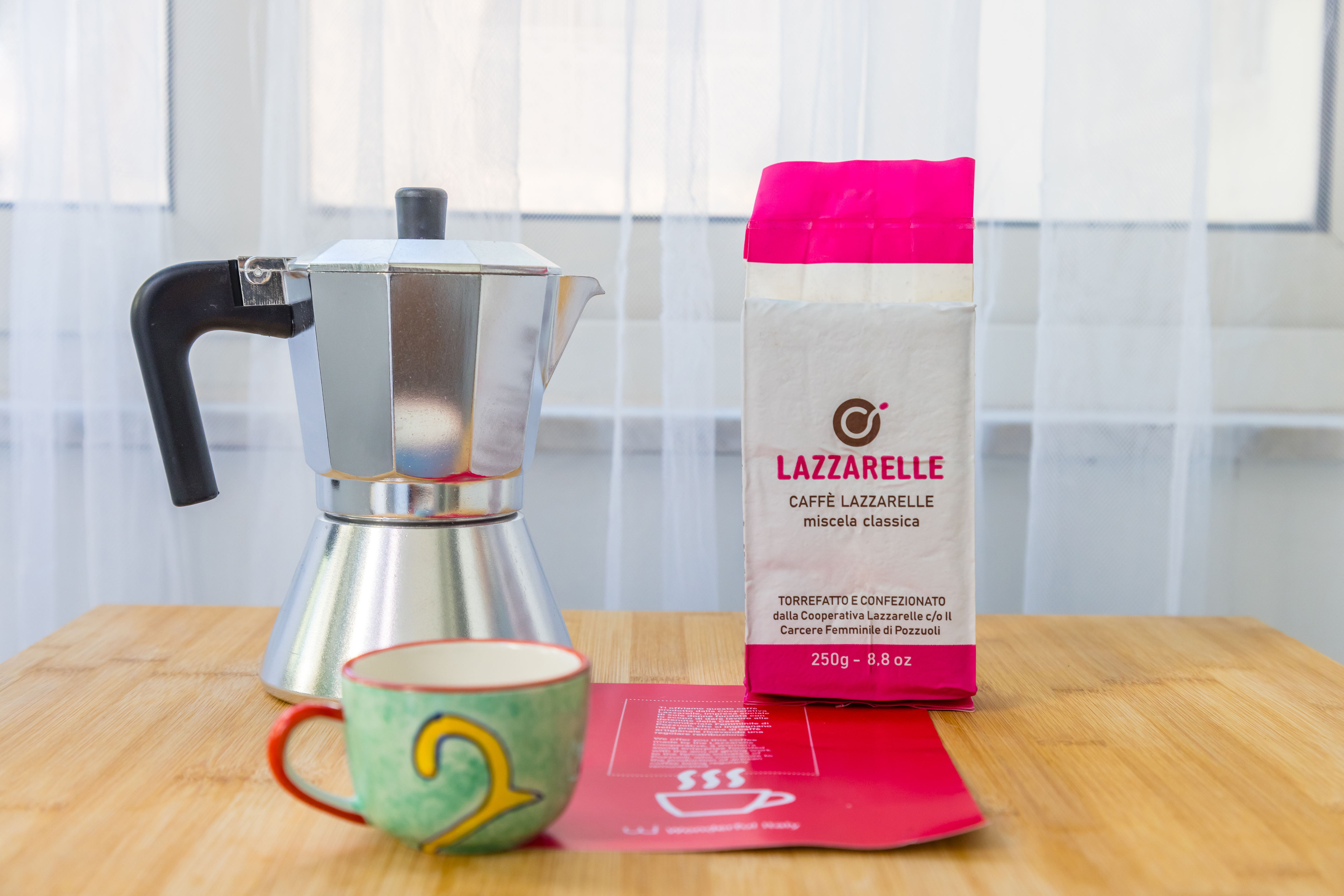 Close-up of a mocha, cup and packet of Lazzarelle coffee, produced by the social cooperative working with Wonderful Italy