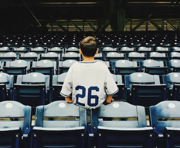 Kid sitting on the stadium bleachers