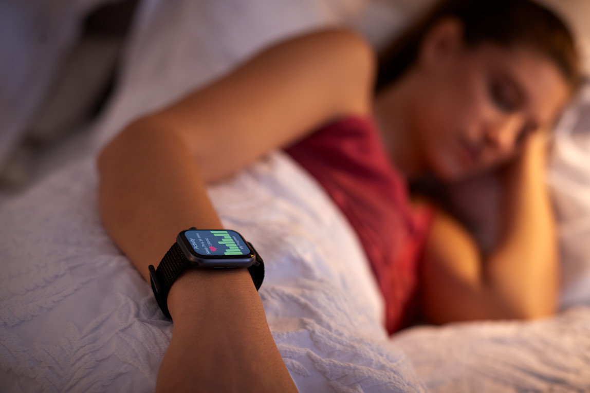 Measuring a woman's sleeping patterns while she sleeps providing sleep analysis on a black smartwatch