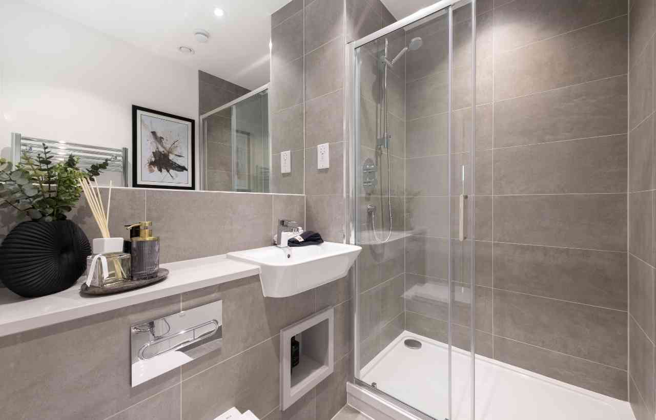 CGI of grey slate tiled shower room with white fittings glass sliding door