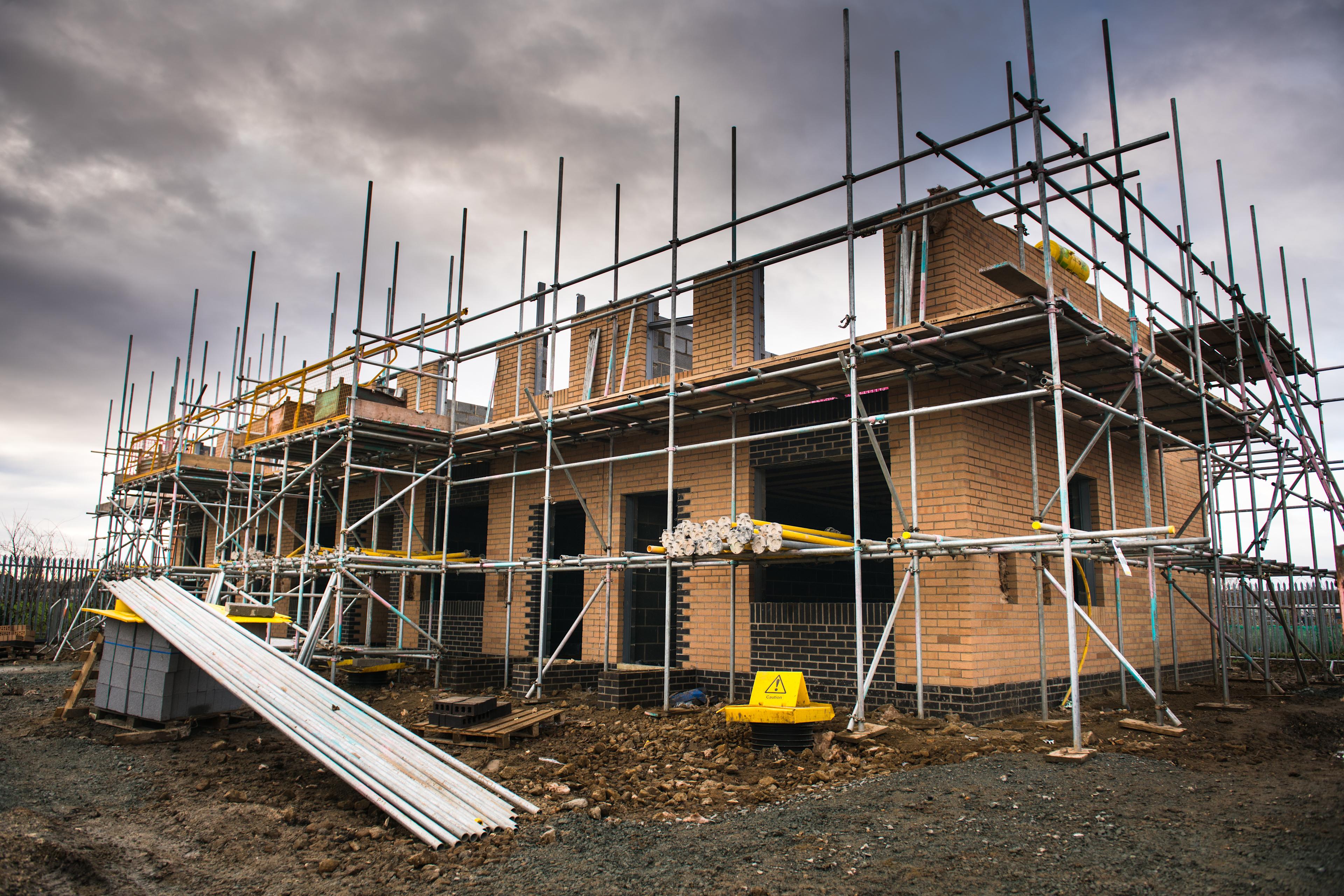 New home being built surrounded by scaffolding 