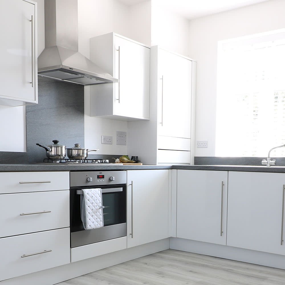 persona-homes-specification-kitchen-white-units-grey-worktops-pale-laminate-floor
