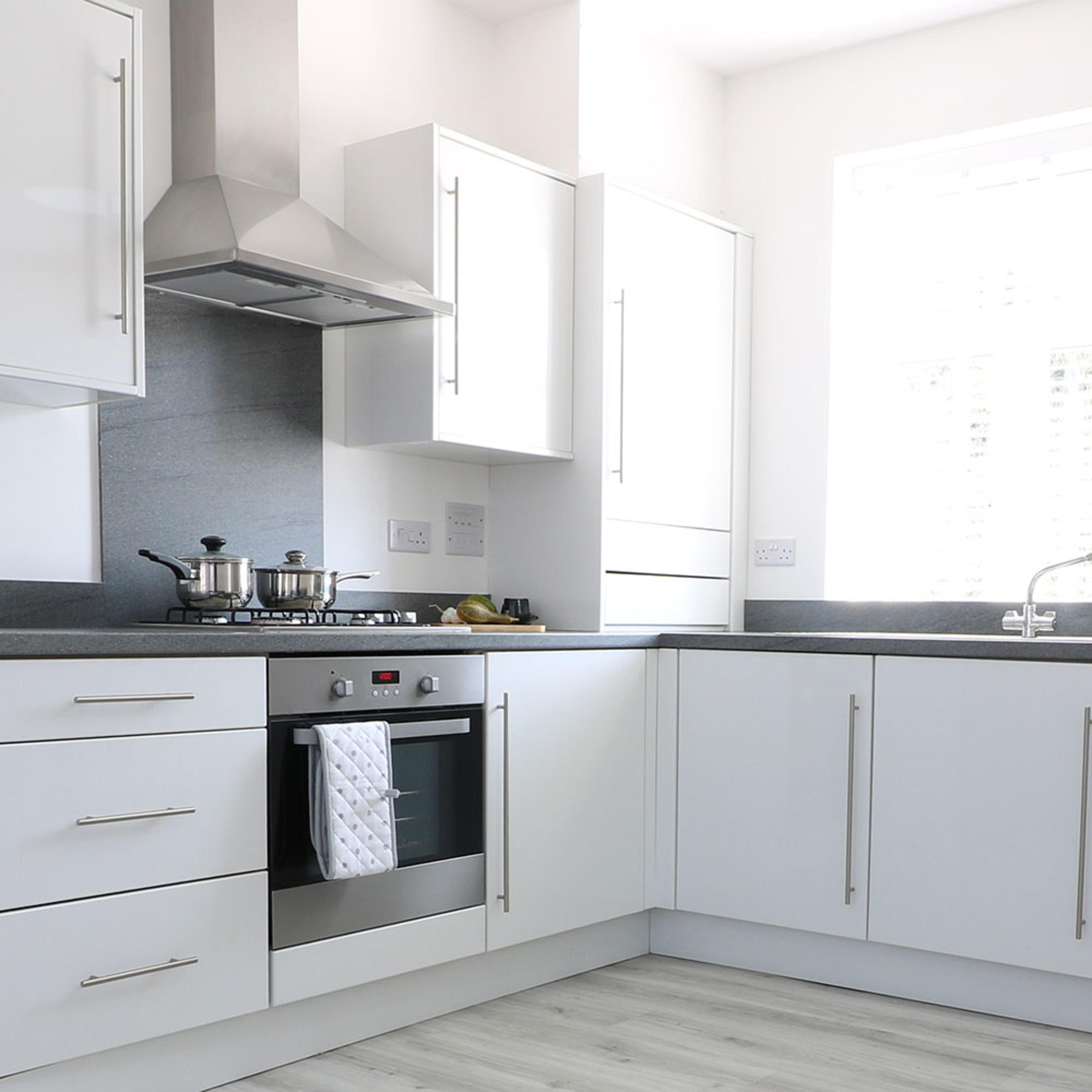 persona-homes-specification-kitchen-white-units-grey-worktops-pale-laminate-floor-unbranded-oven-hood
