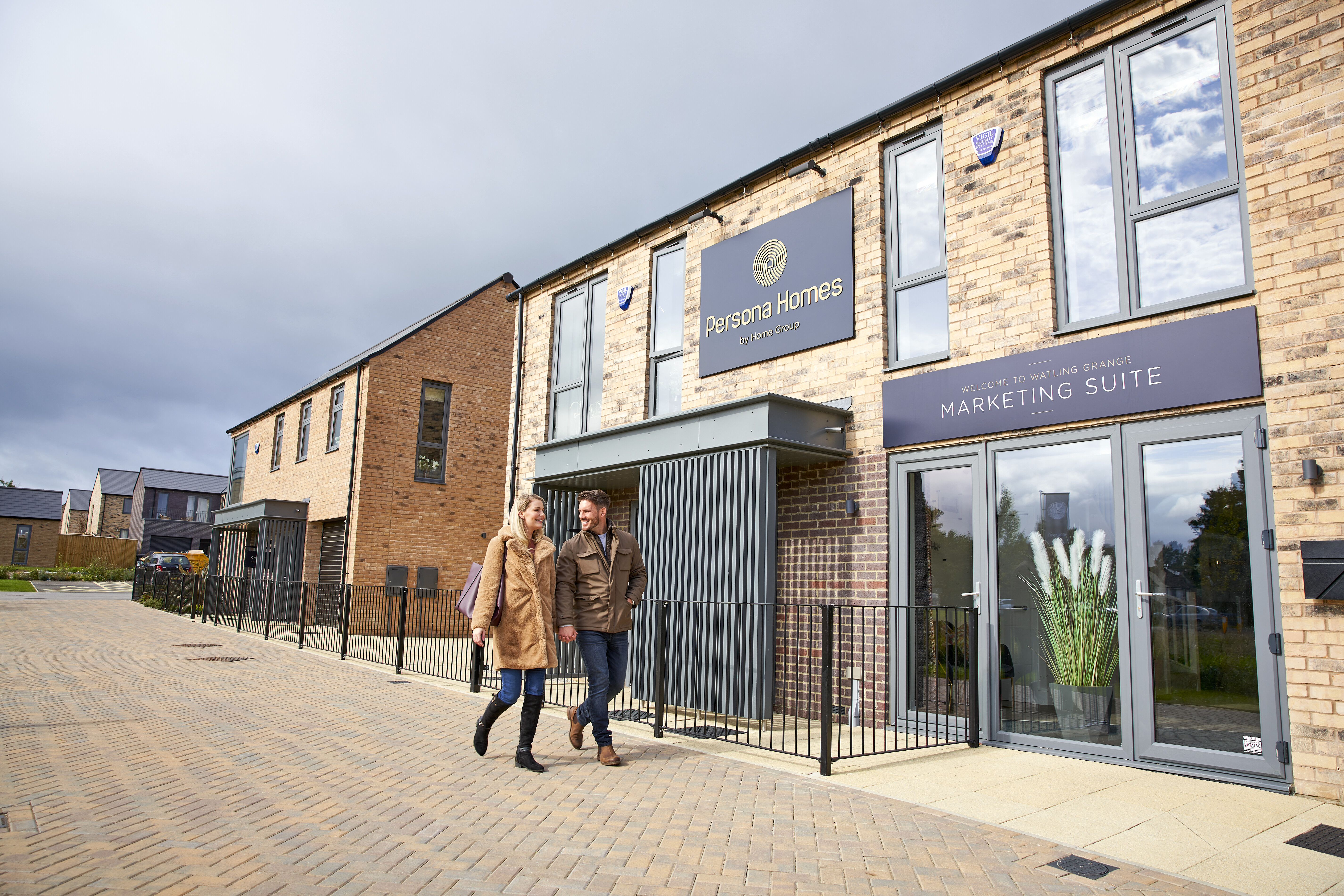 Couple walking in front of the marketing suite