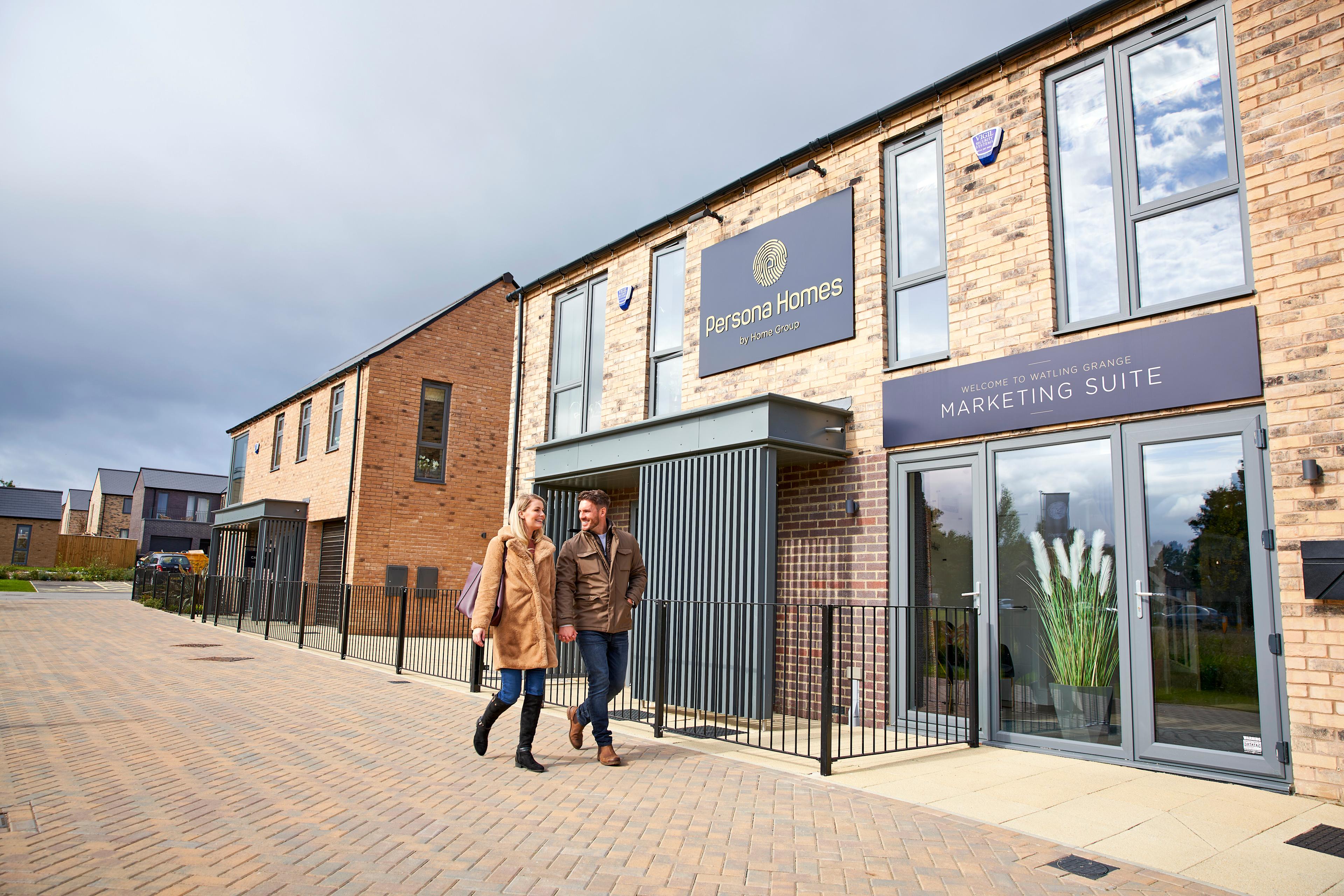 Couple walking in front of the marketing suite