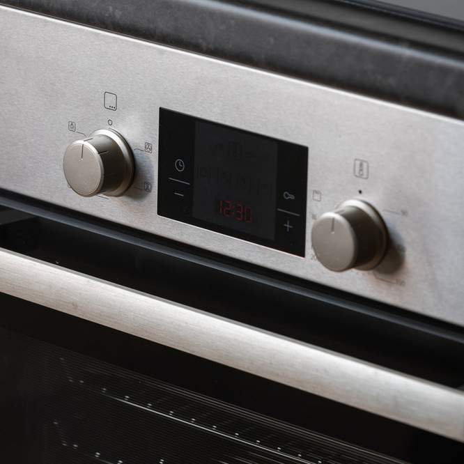 Close up of controls on a silver oven