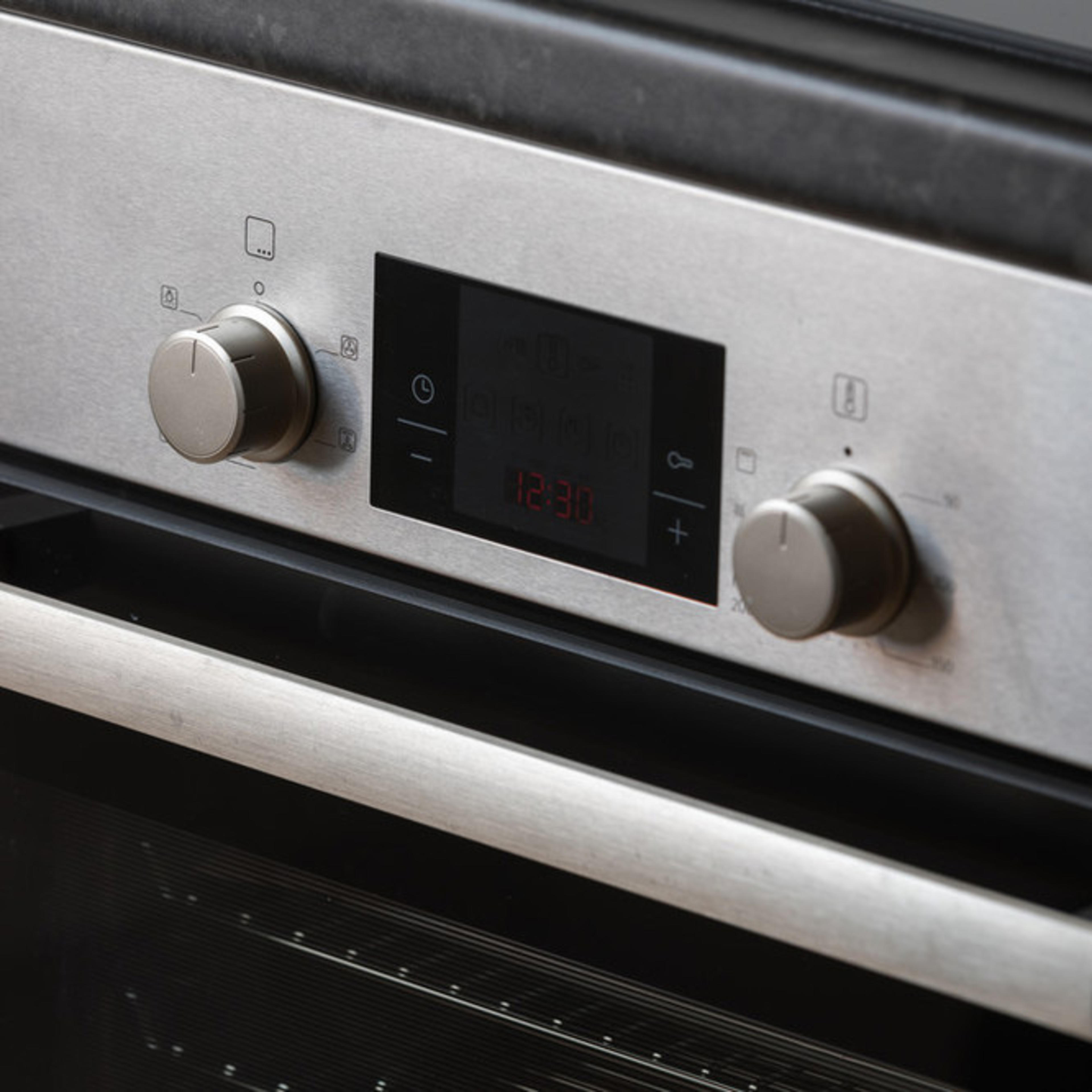 Close up of controls on a silver oven