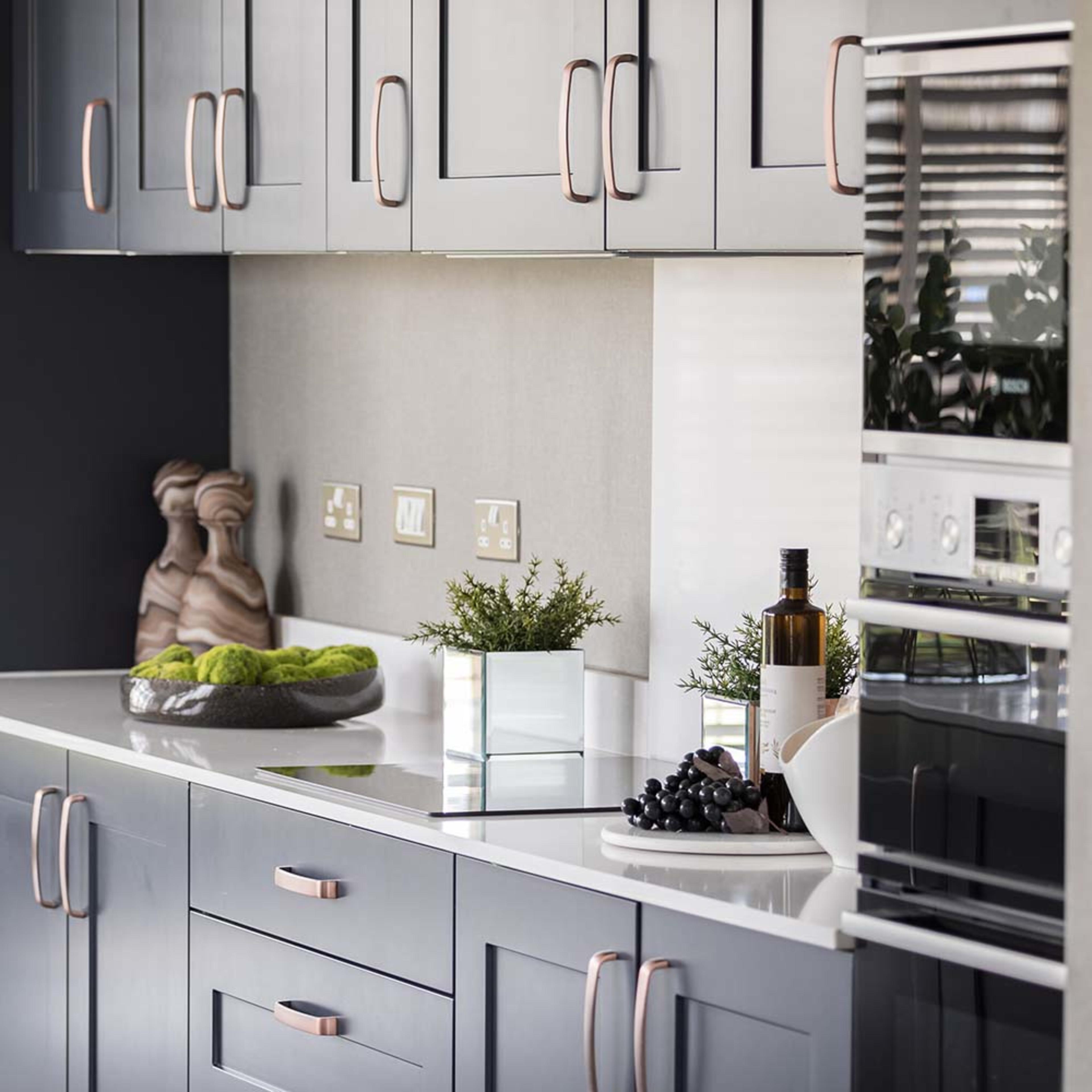 persona-homes-specification-kitchen-closeup-double-oven-blue-units-white-worktops