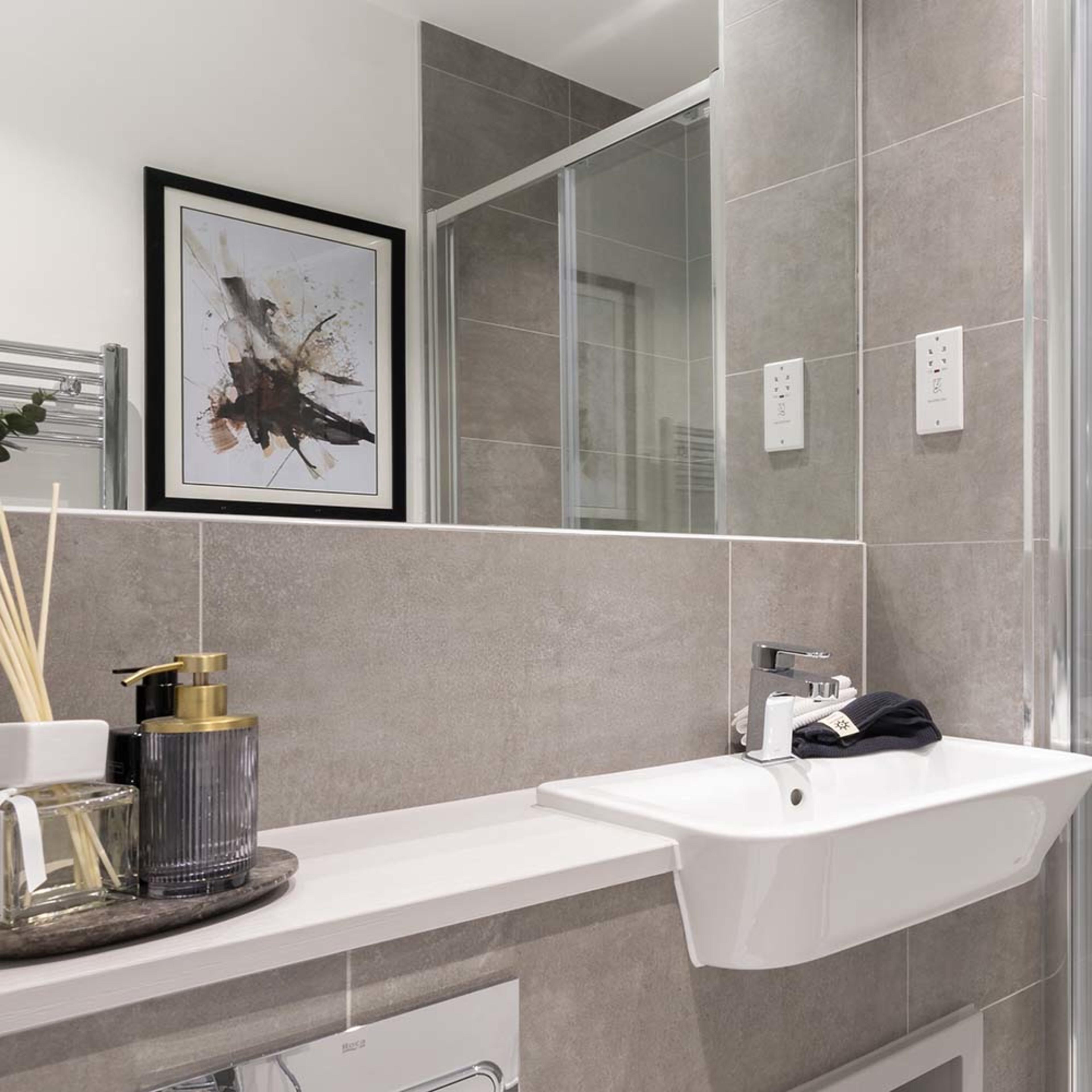 persona-homes-specification-bathroom-closeup-dark-tiles-white-sink-mirror-wall