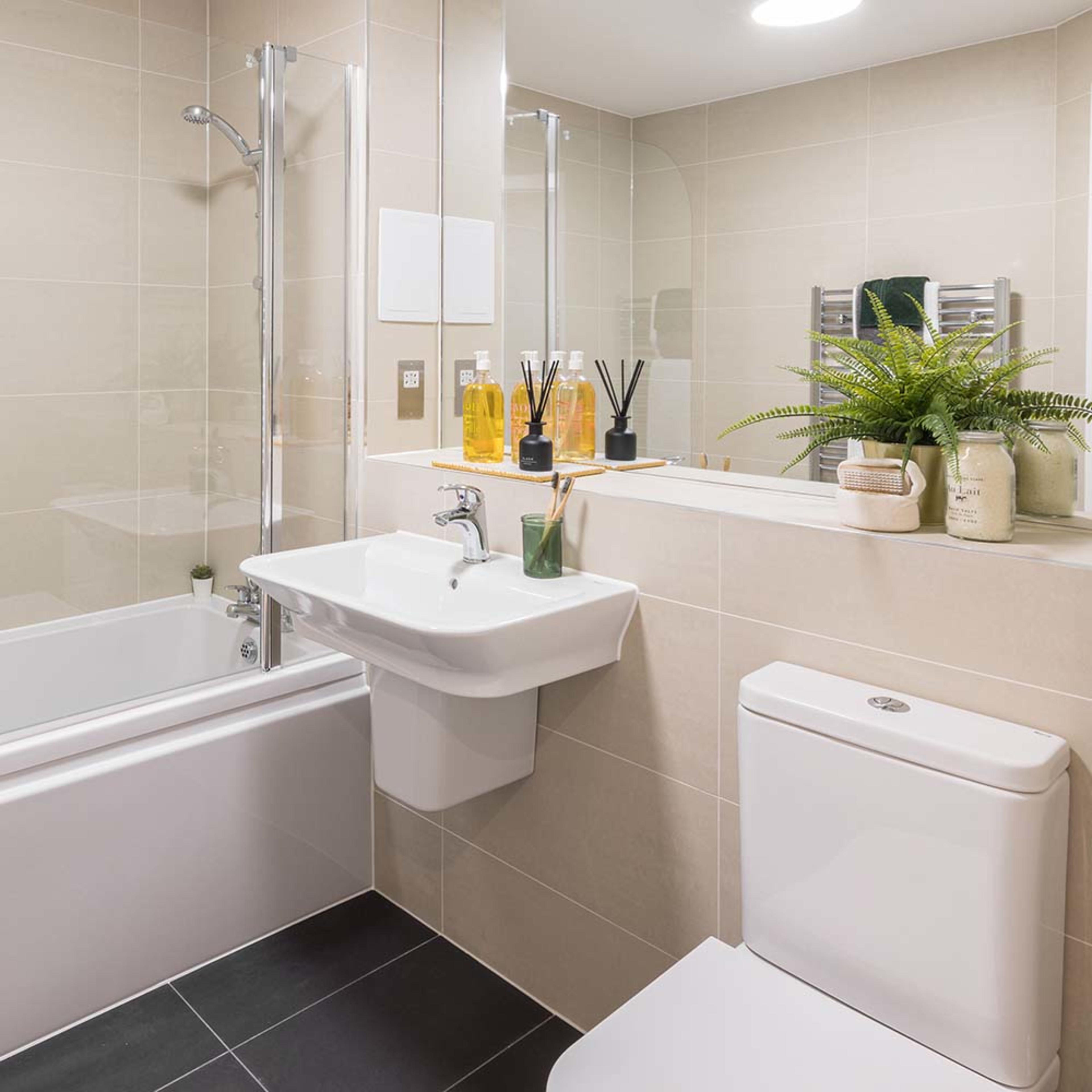 persona-homes-specification-bathroom-beige-tiling-dark-floor-shower-over-bath