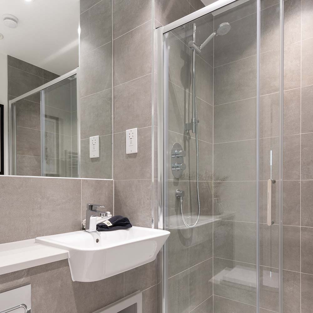 persona-homes-specification-bathroom-shower-room-dark-tiles-white-sink