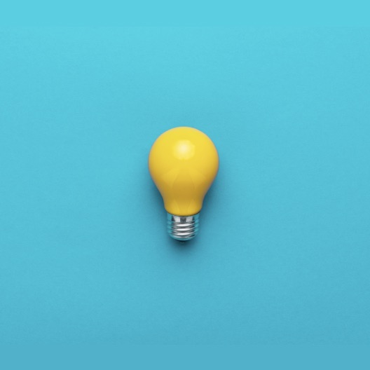 Yellow lightbulb on Blue Background (medium)