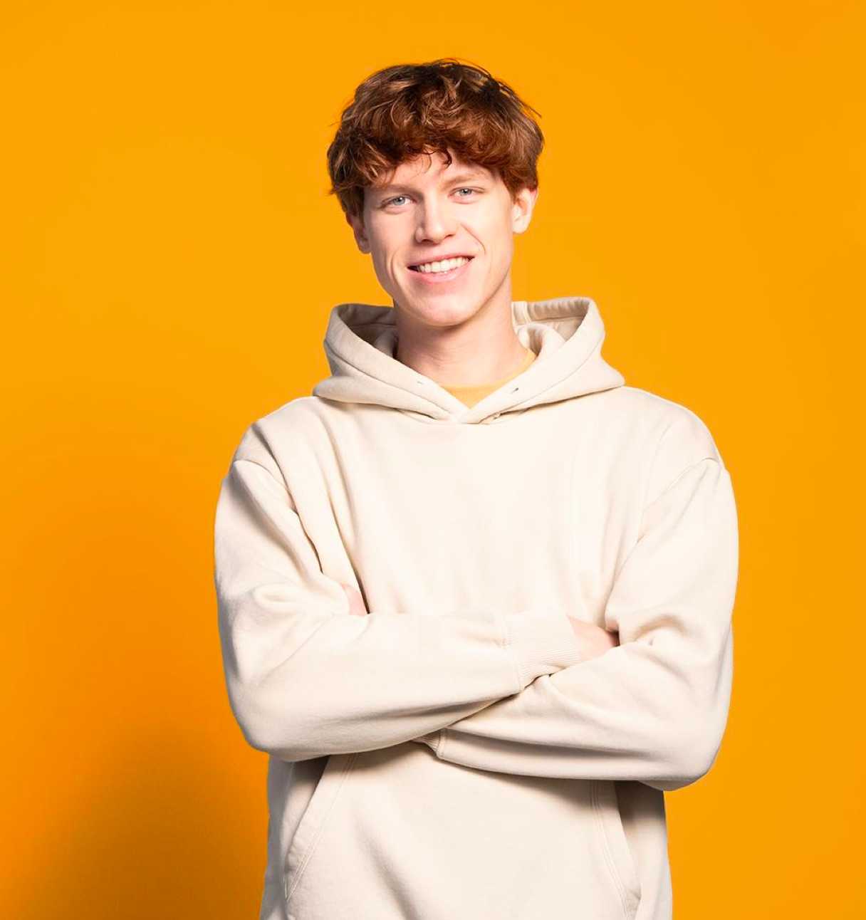 Smiling young man with crossed arms (top block)