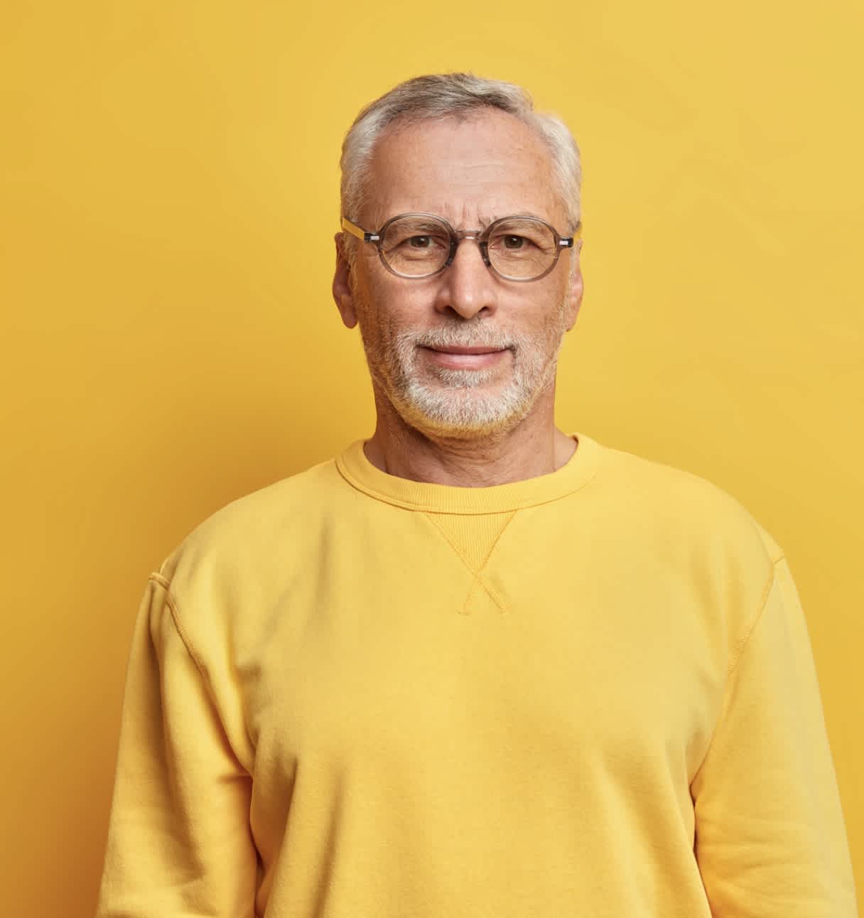 Senior man wearing yellow sweater (top block)