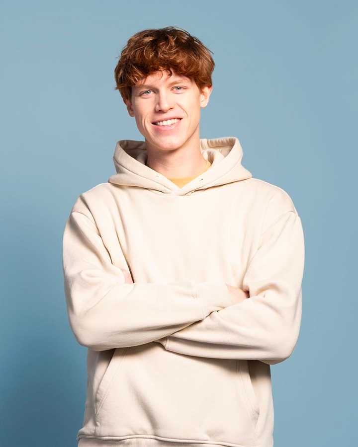 Smiling young man with crossed arms (large card - 3col)