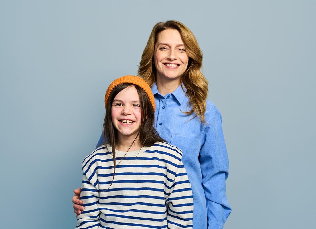 Mother and daughter smiling at camera (CTA)