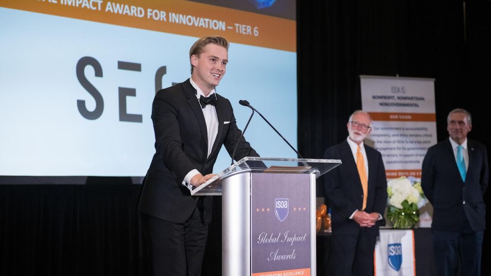 Seon co-founder and CEO Finn Plotz accepting a global impact award. (Image courtesy of Seon.)