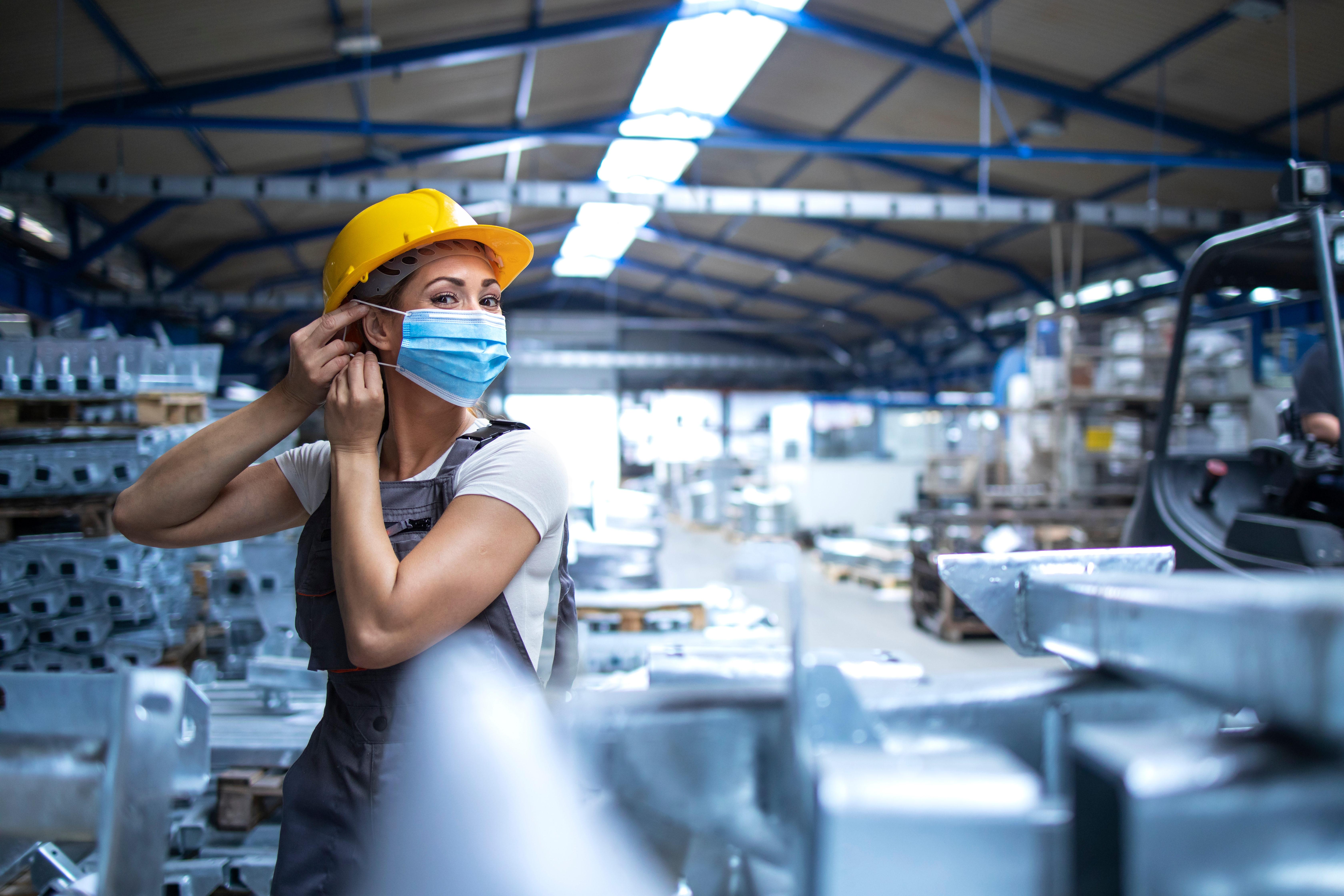 Factory worker working during COVID-19 pandemic. Image courtesy of Shutterstock.