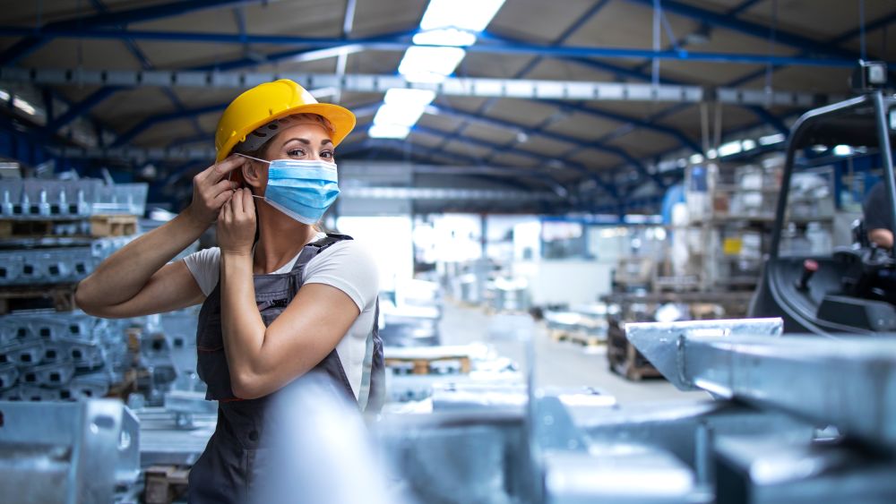 Factory worker working during COVID-19 pandemic. Image courtesy of Shutterstock.