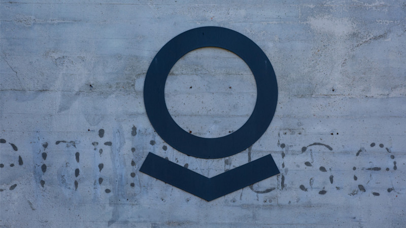 Palantir logo on the grunge concrete wall of Palantir Technologies cafeteria