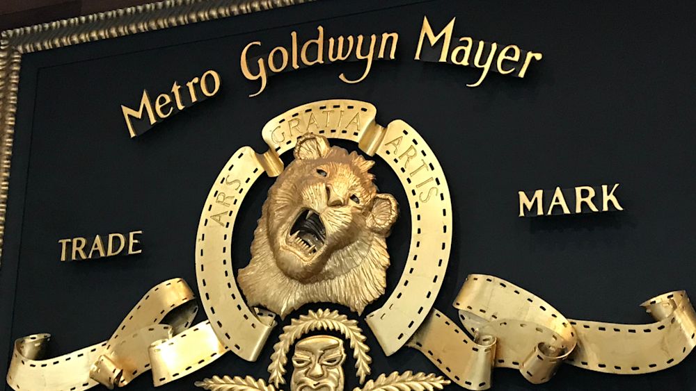Close-up of the MGM logo that hangs above the front desk at MGM Studios in Beverly Hills, CA. Editorial credit: Alex Millauer / Shutterstock.com