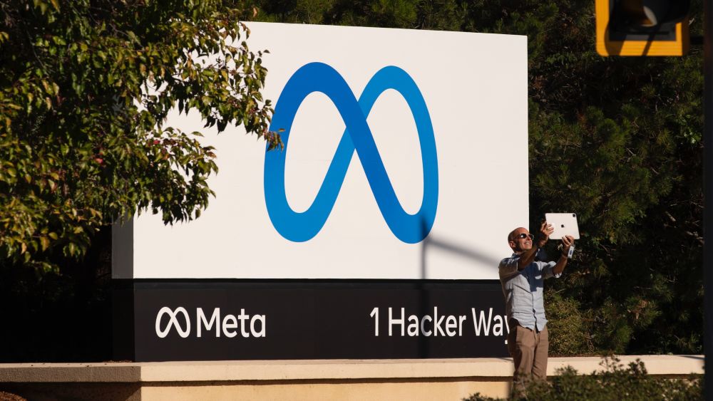 A man takes pictures in front of a sign showing logo of Meta outside Facebook headquarters on October 28, 2021 in Menlo Park, California. (Photo by Liu Guanguan/China News Service via Getty Images)