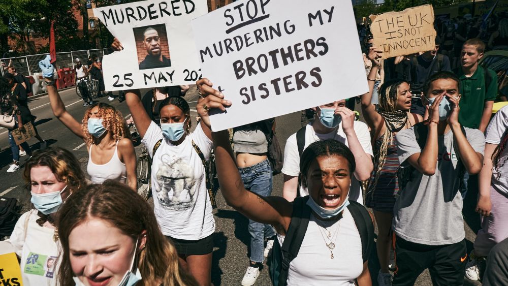 Black Lives Matters protesters holding signs and marching outside the American Embassy in London, May 2020. Editorial Credit: Matteo Roma, Shutterstock