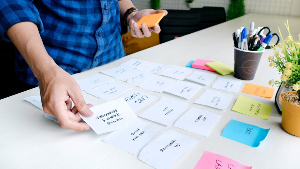 Product manager sorting sticky notes for the product development roadmap
