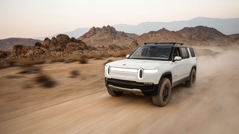 A Rivian R1S electric vehicle driving in the desert. Image credit: Jeff Johnson, Rivian