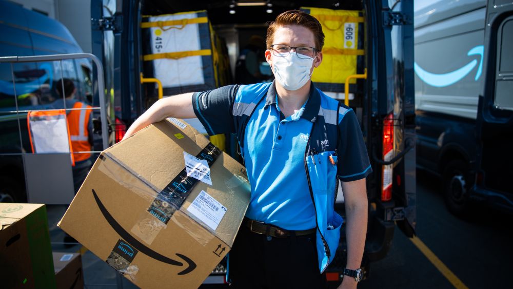 Delivery driver with package. Image courtesy of Amazon.