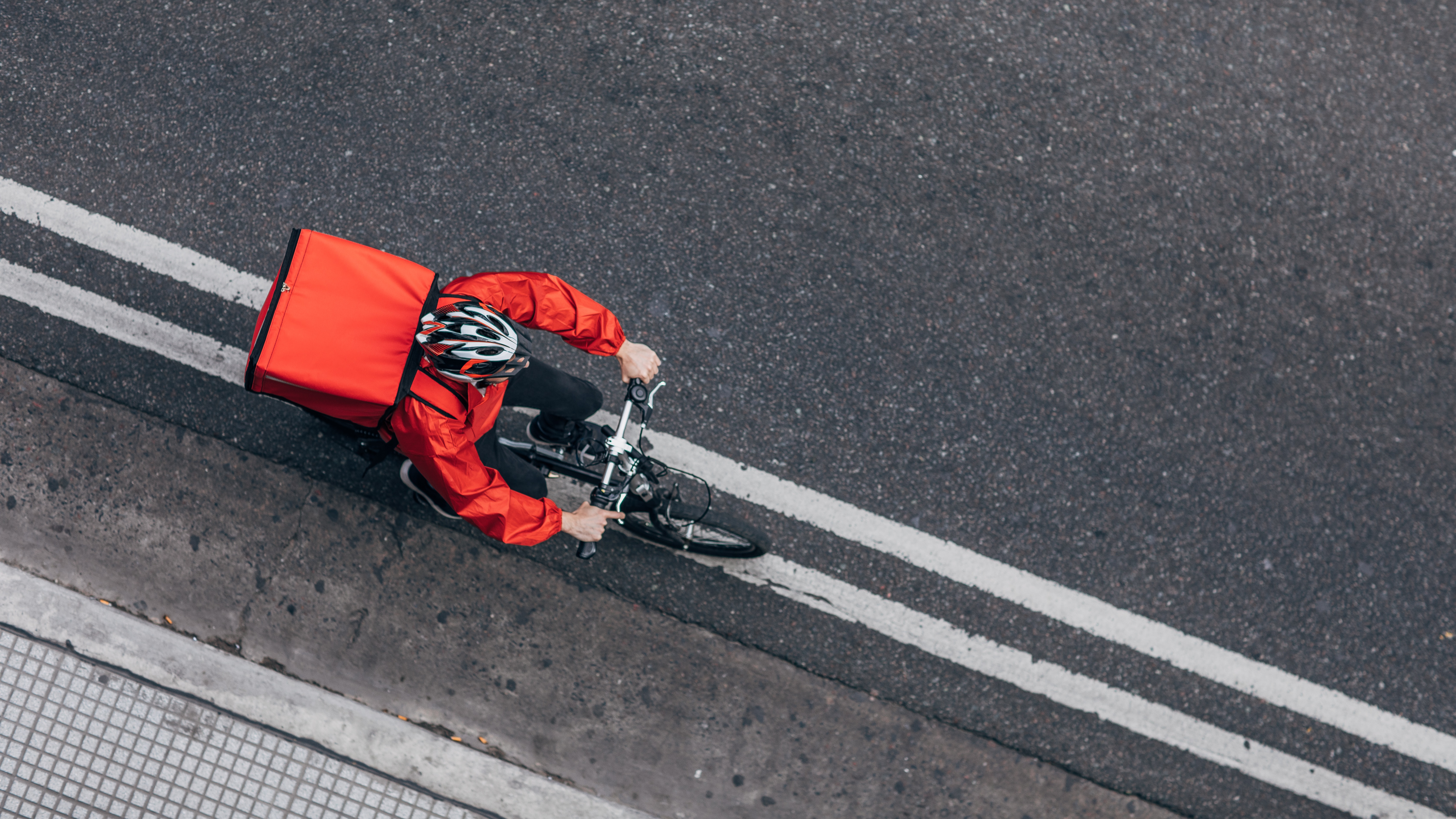 Delivery person on bicycle. Image credit: Getty Images.