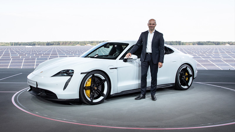 Manfred Harrer standing next to a Porsche Taycan