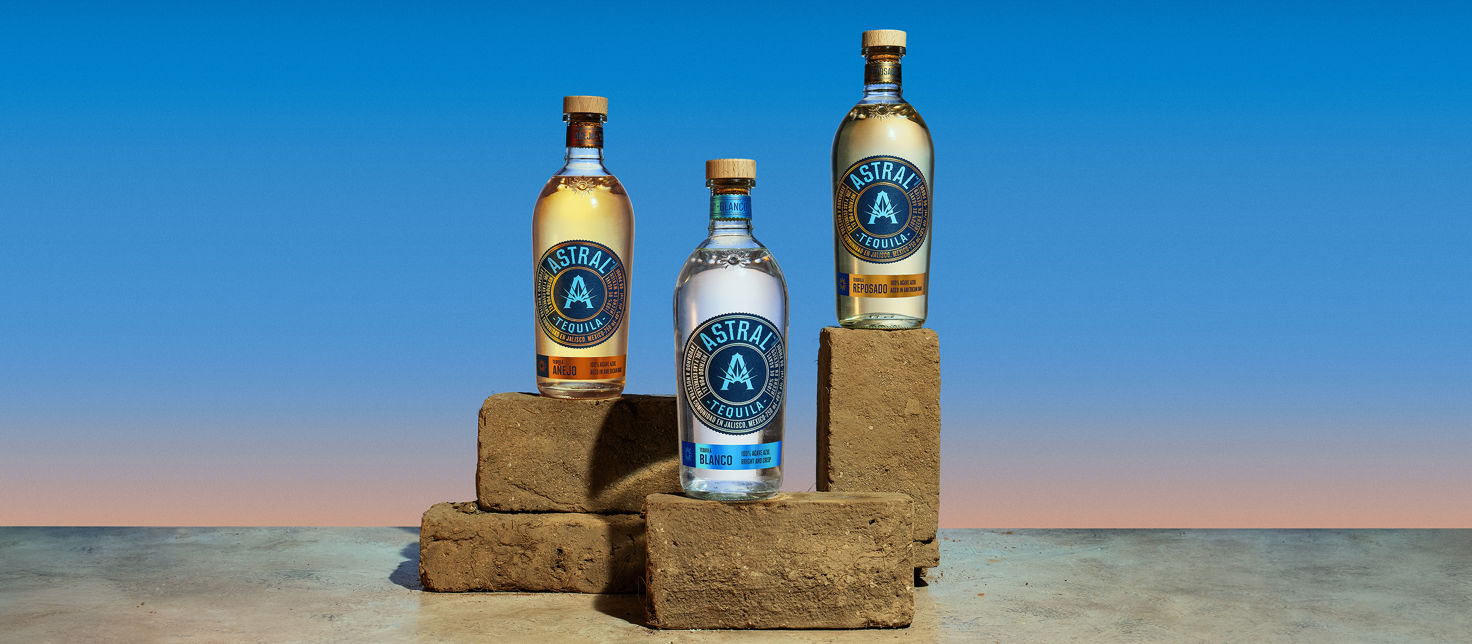 A collection of Astral Tequila products around a cocktail