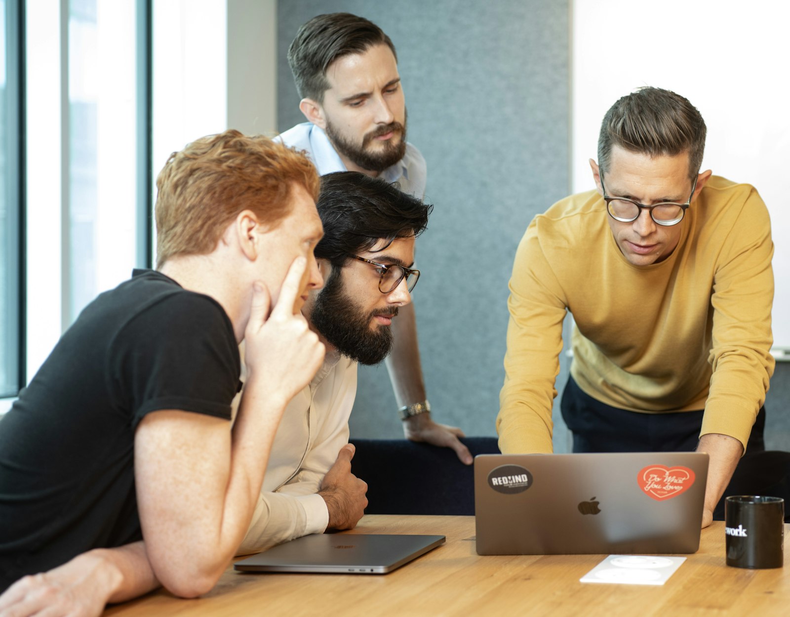 Marketing team collaborating on automated content workflows, reviewing blog automation features and AI-powered publishing tools on multiple screens